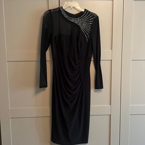 Black cocktail dress with sheer top and detail